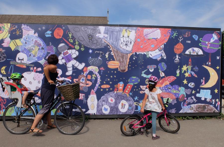Hoardings with cyclists in front