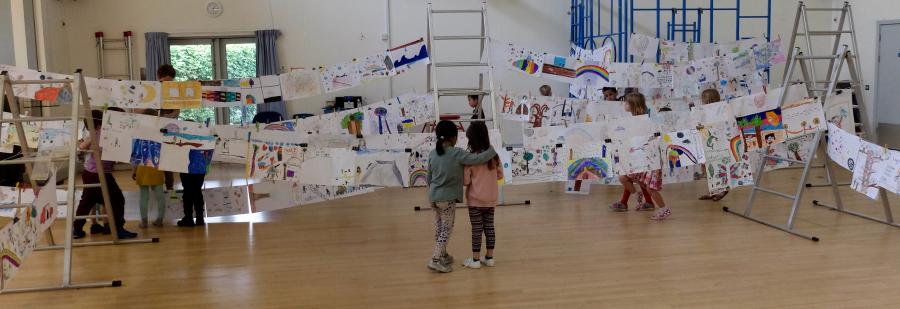 Children in front of artwork in hall