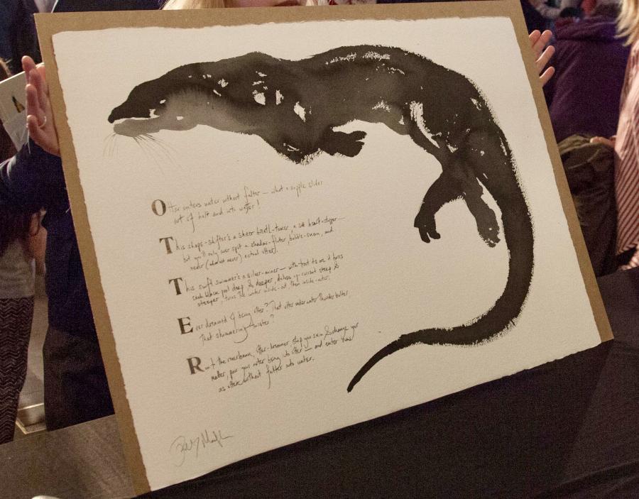 Large painting of otter and poem held aloft