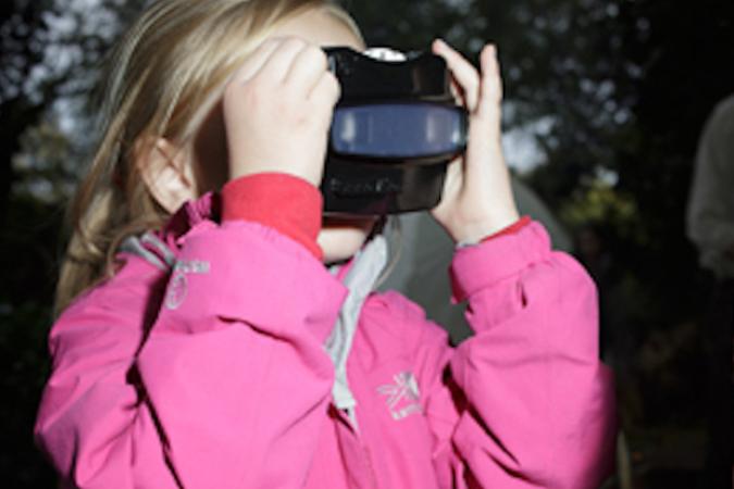 A child looking through a viewfinder